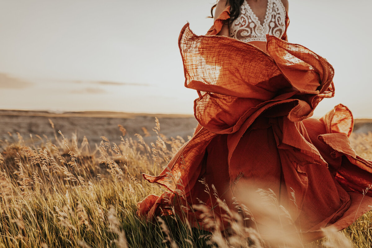 woman twirls dress in field