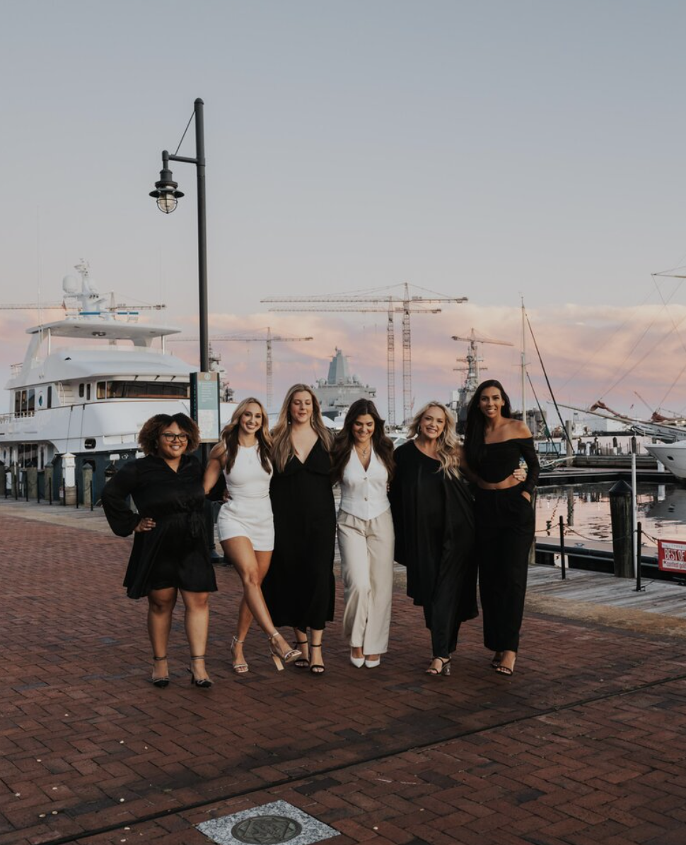 This image captures a moment of camaraderie among members of The Bold Babe Society, a female-focused organization, as portrayed on their website design aimed at building a strong community.