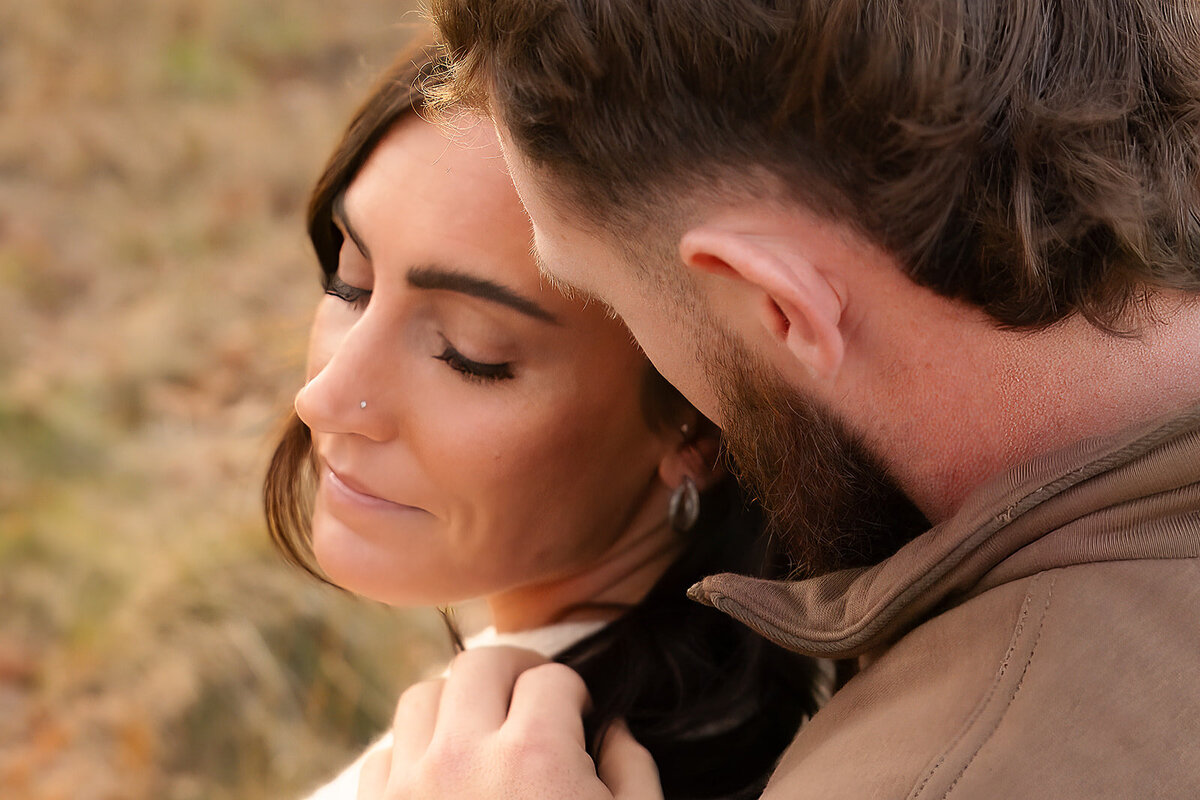 man looking at woman and playing with her hair