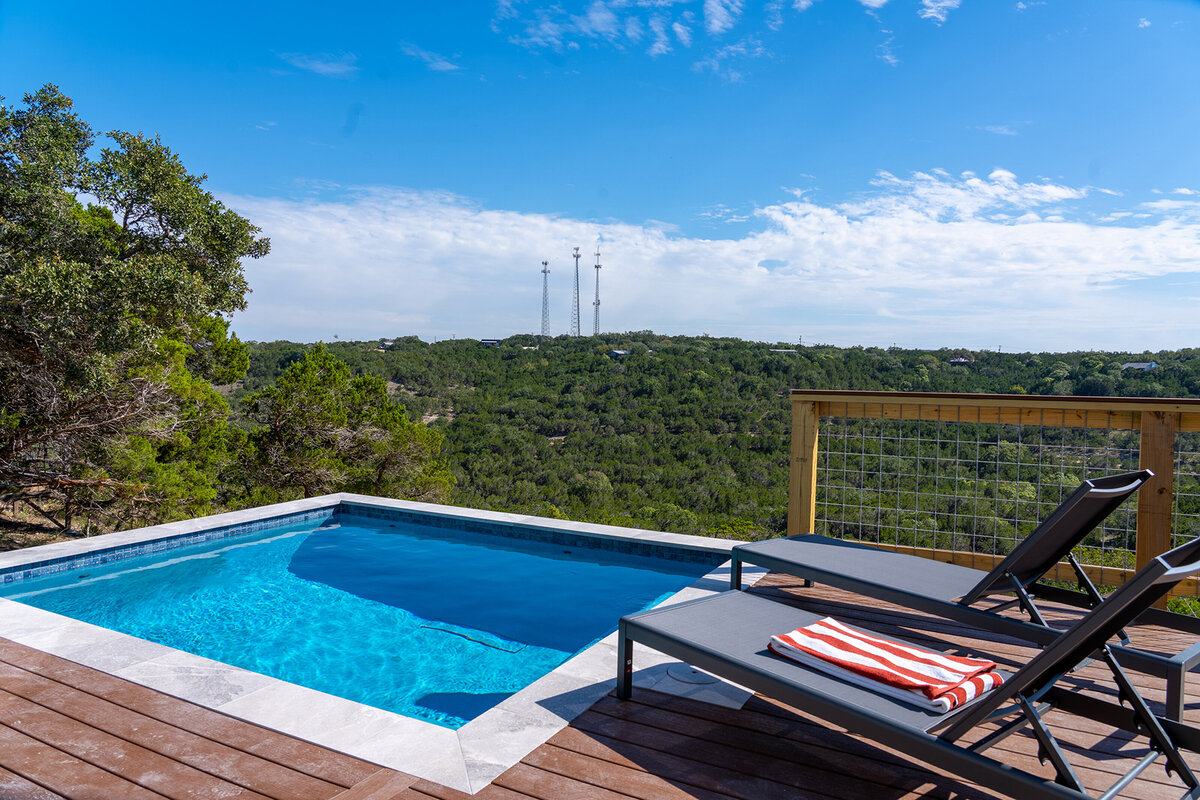 backyard pool overlooking beautiful view of treetops in Texas Hill Country