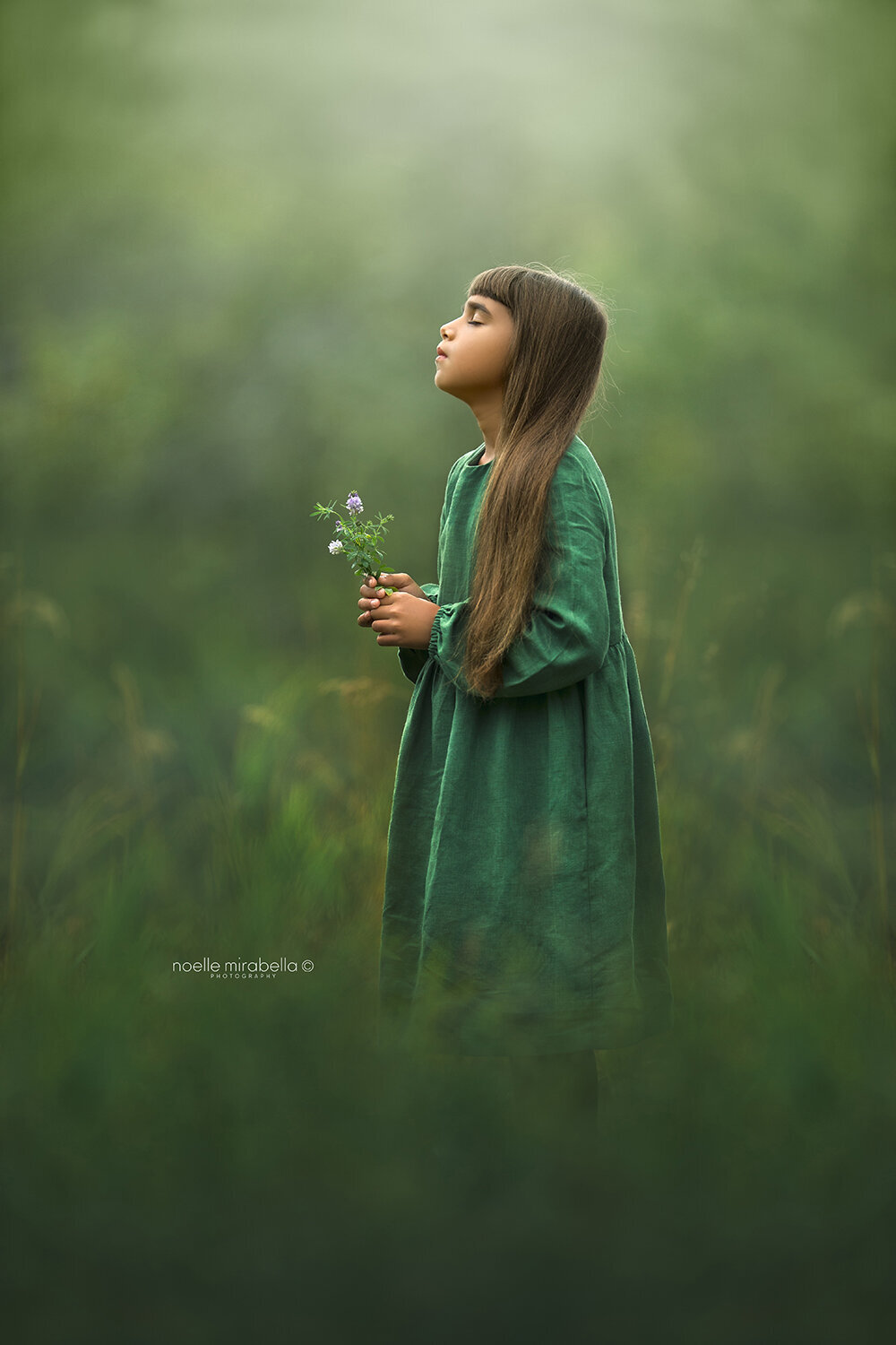 Girl Standing in nature with peaceful expression.