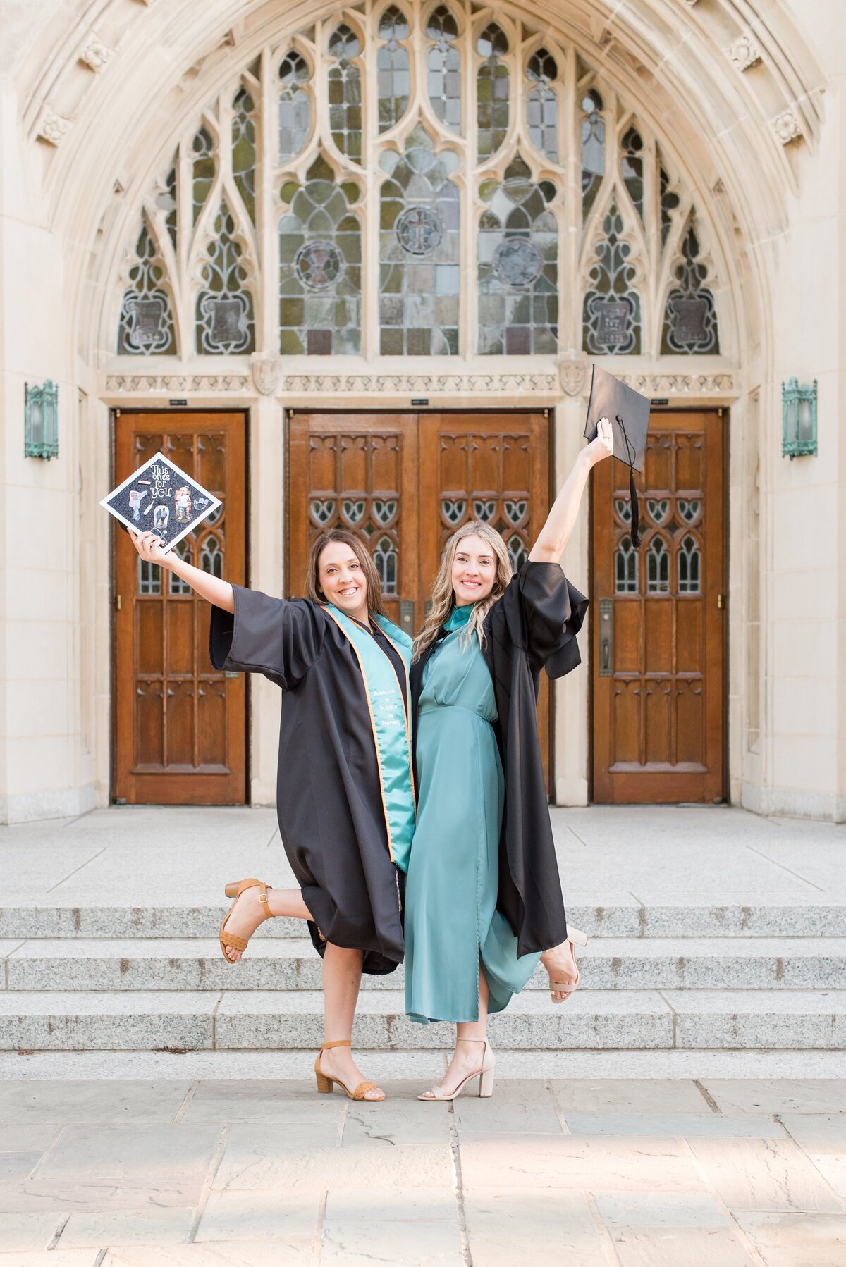 graduate sisters holding caps out