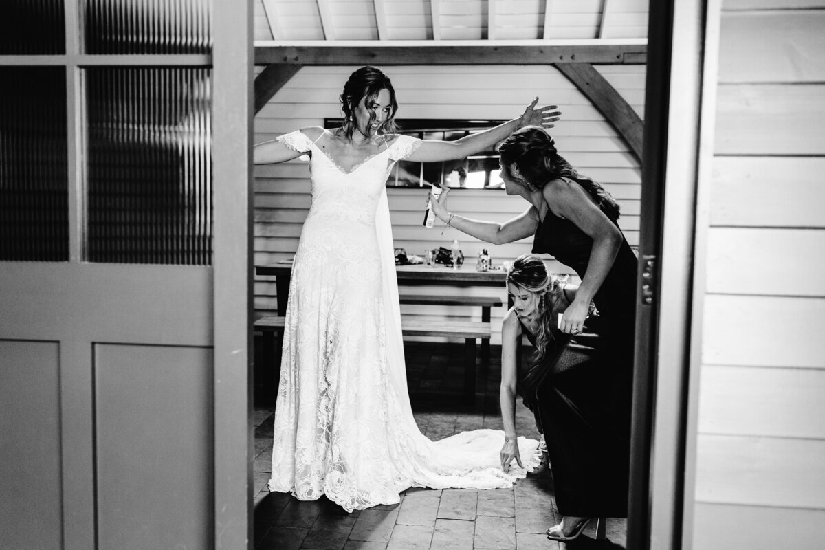 Black and White photo of bridesmaids getting ready with bride