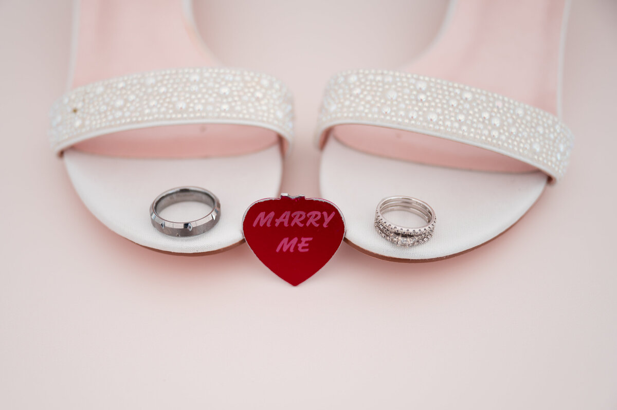 brides wedding shoes with rings placed artistically