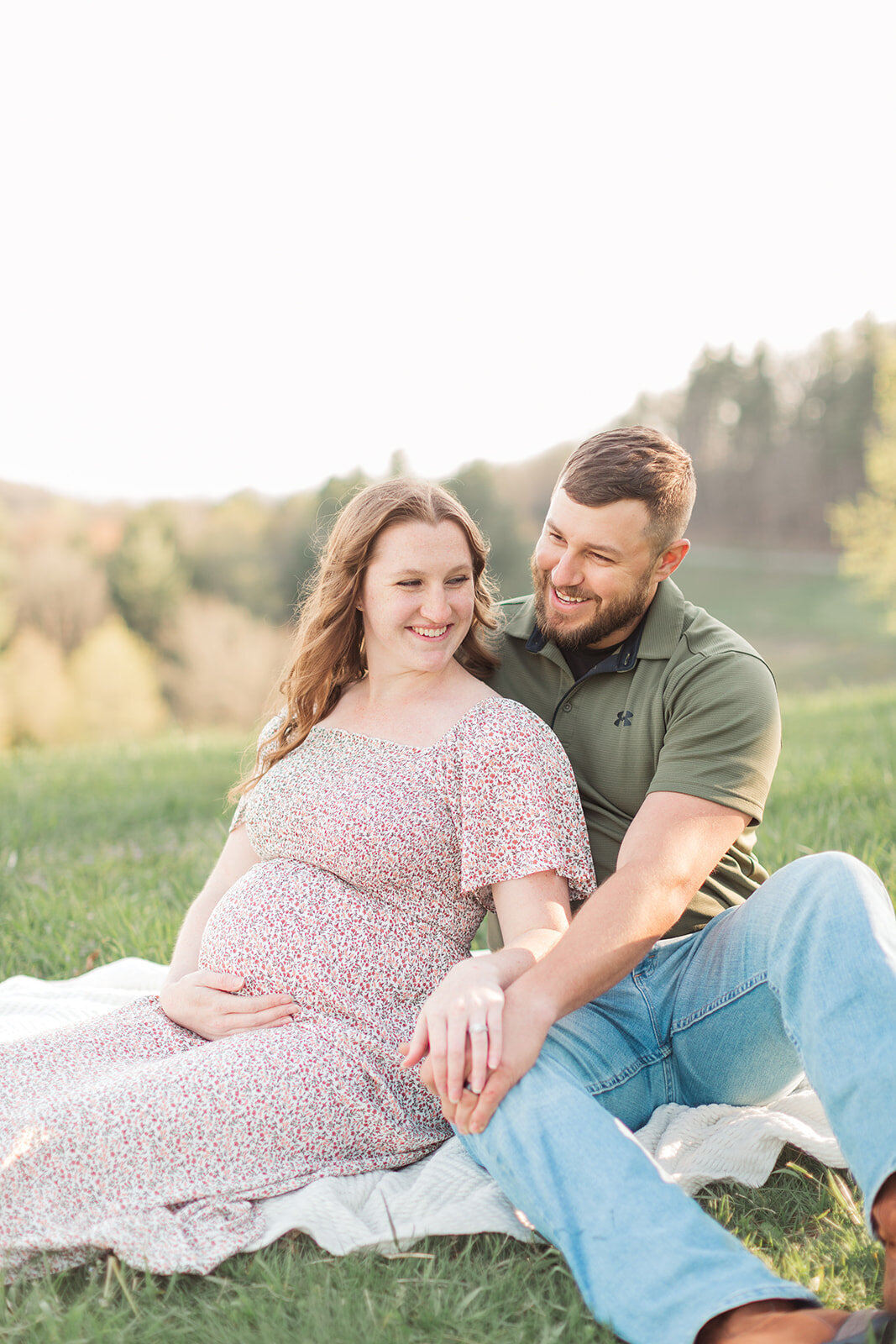 Couple snuggled up together during mountain maternity session
