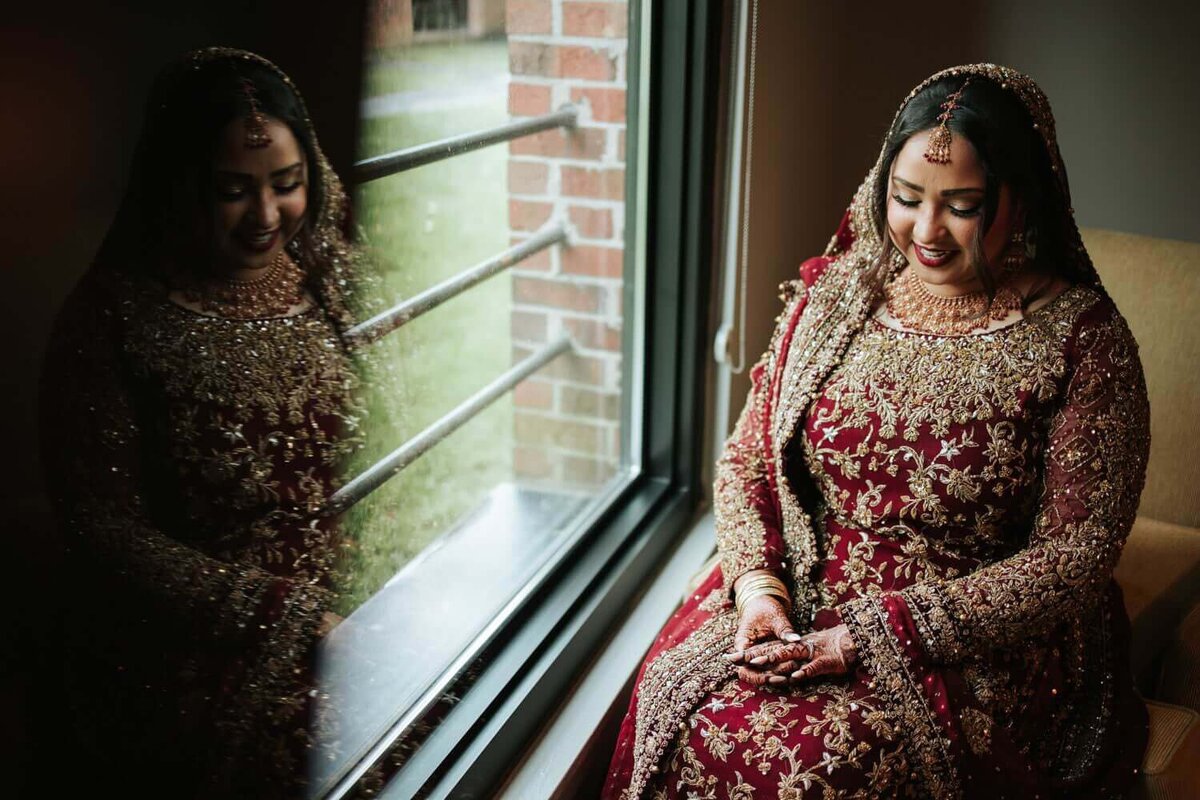 South Asian Bride during her bridal portraits smiling in excitement for her reception night in Princeton New Jersey.