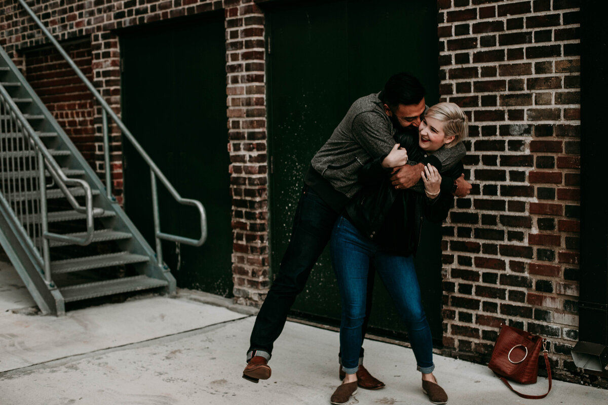 couple playfully hugs during engagement session