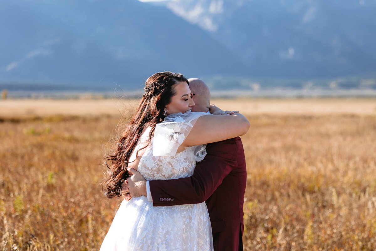 A couple hugging after eloping at Mormon Row in Grand Teton National Park near Jackson Hole, Wyoming