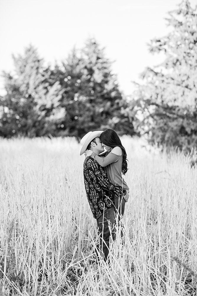 Country couple kissing in field