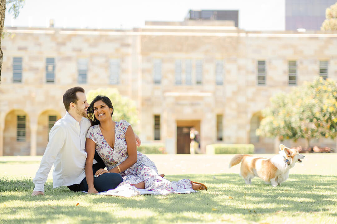 couple having intimate photo session with pet corgi at uq great court st lucia