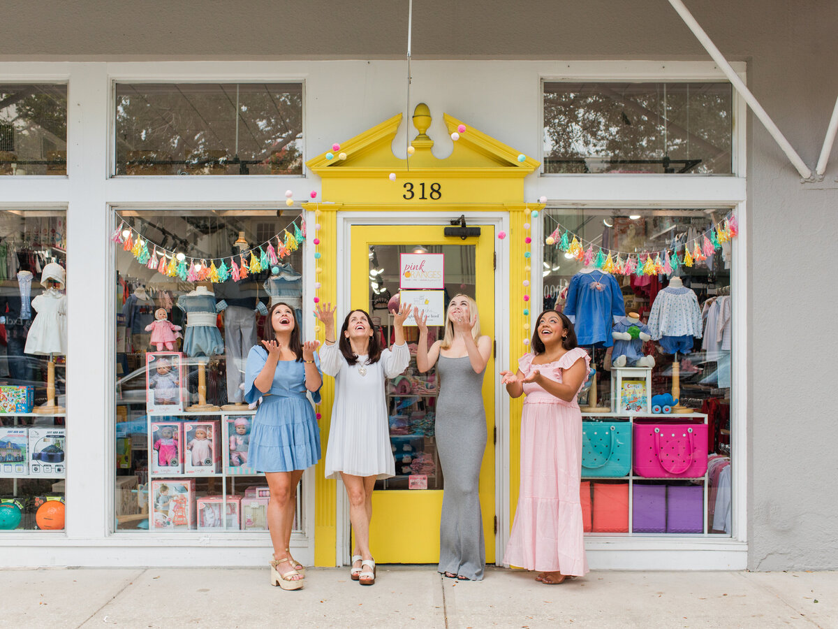 retail entrepreneur and team in front of store by Orlando brand photographer