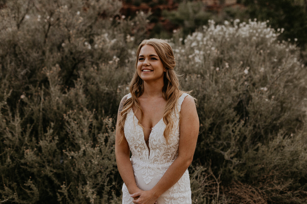 bride smiling in her lace wedding dress