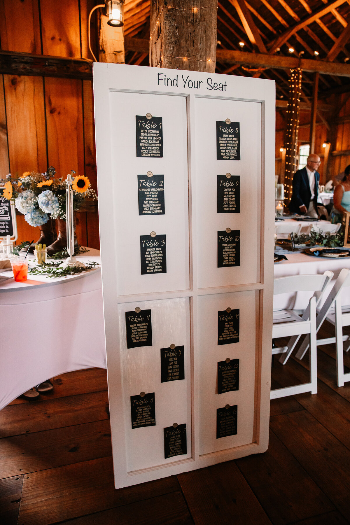 A wooden door used to display table assignments at a reception