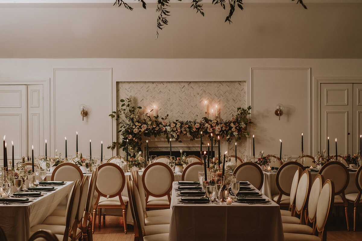Beautiful garden flower arrangements paired with elegant place settings for a wedding reception at the Atwater Club.