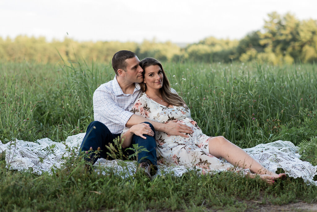 Couple sitting in field at summer sunset maternity session | Sharon Leger Photography | CT Newborn & Family Photographer | Canton, Connecticut