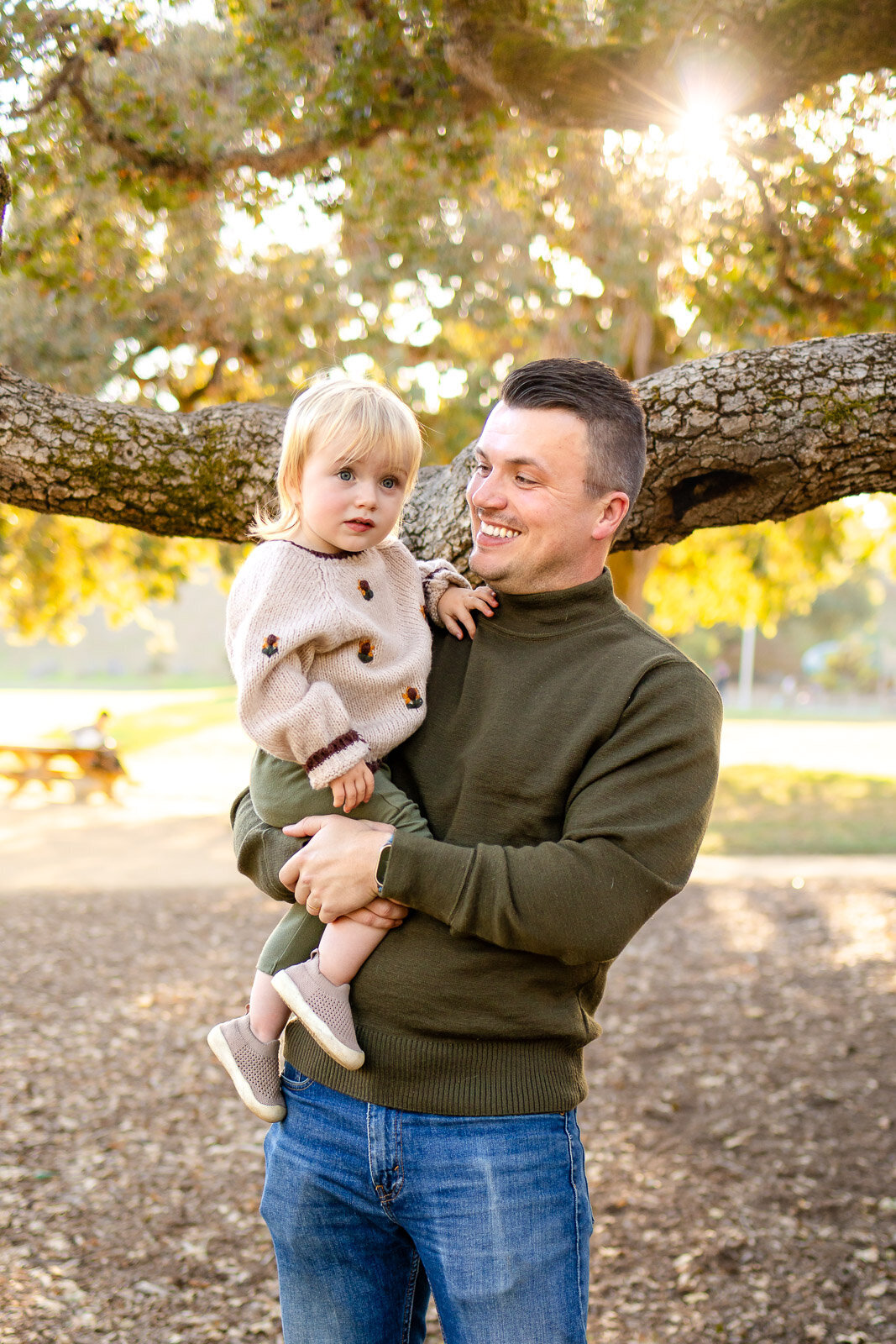 Father holding his toddler under the oak trees at Laurelwood Park San Mateo for the Bay Area Family Portfolio, Ellobelle Photography