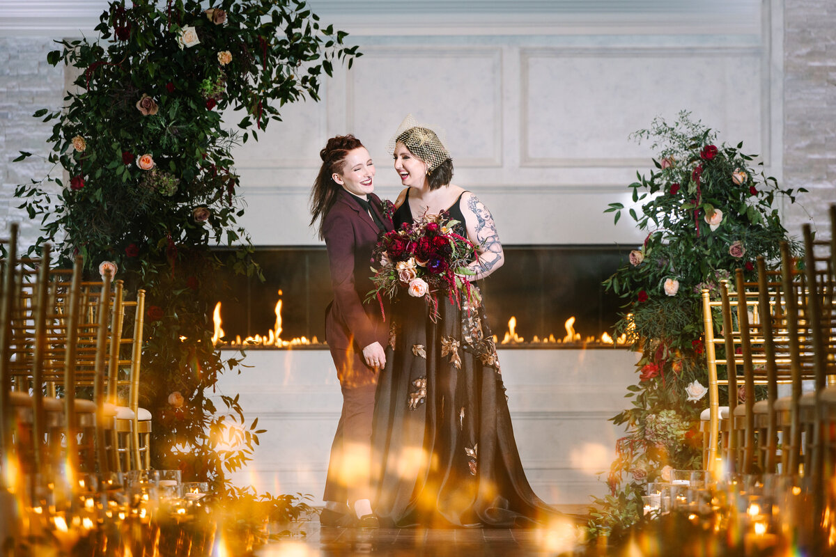 Brides laughing with candle lights at the bottom of the photo