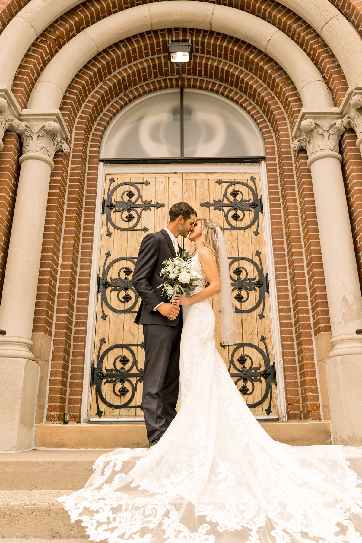 Bride and groom outside of the church on their wedding day