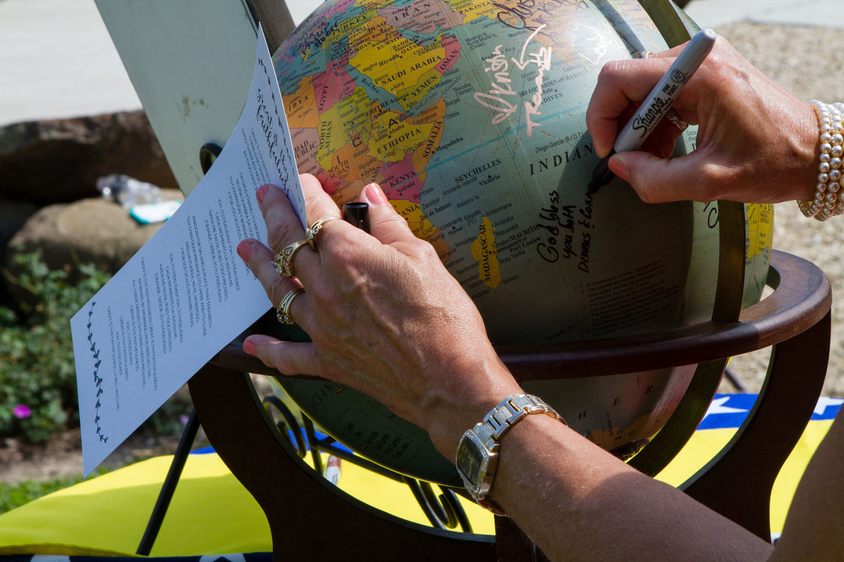 guests sign globe as guestbook