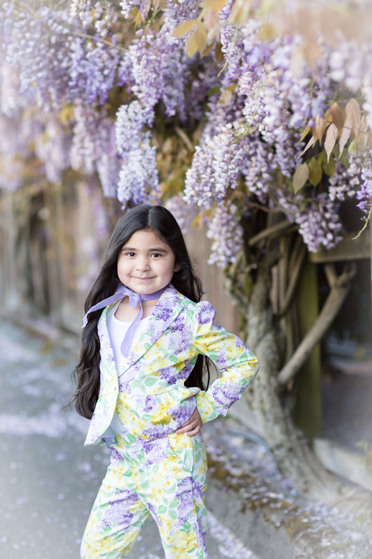 Girl posing in Seattle amongst the wisteria blossoms