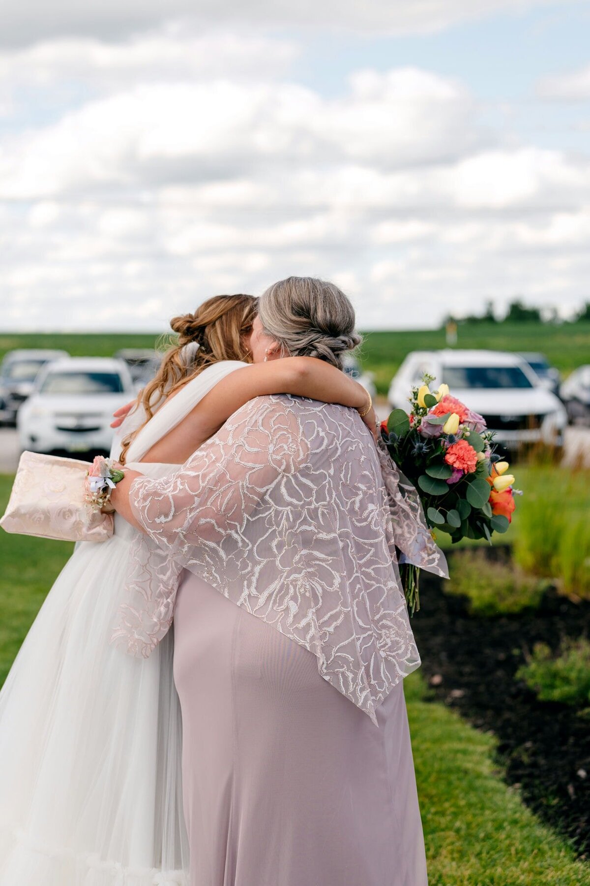 mother-whispering-into-brides-ear