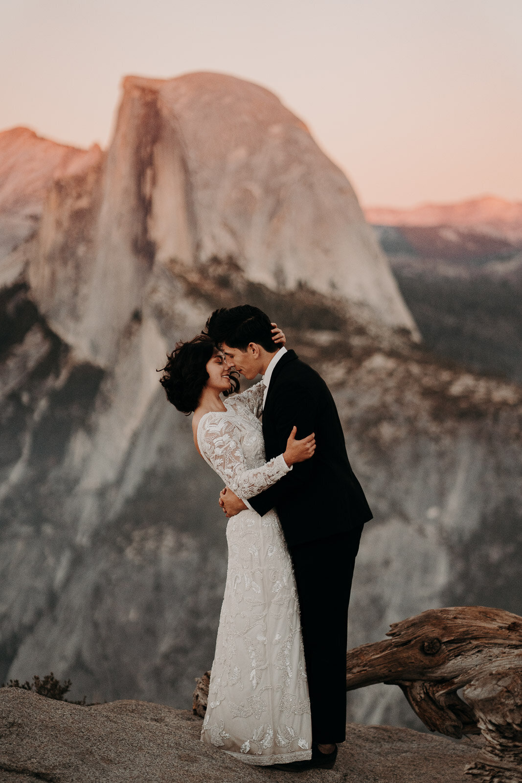 bride and groom going in for a kiss in front of the Yosemite dome