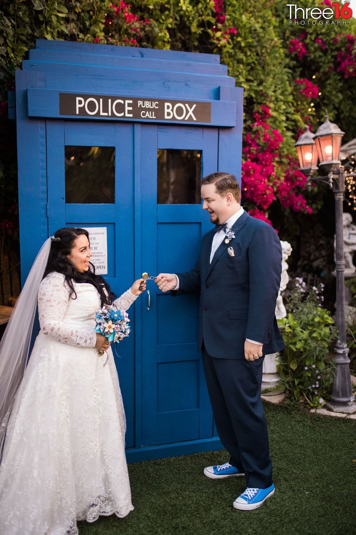 Bride and Groom about to open the doors to a public police box