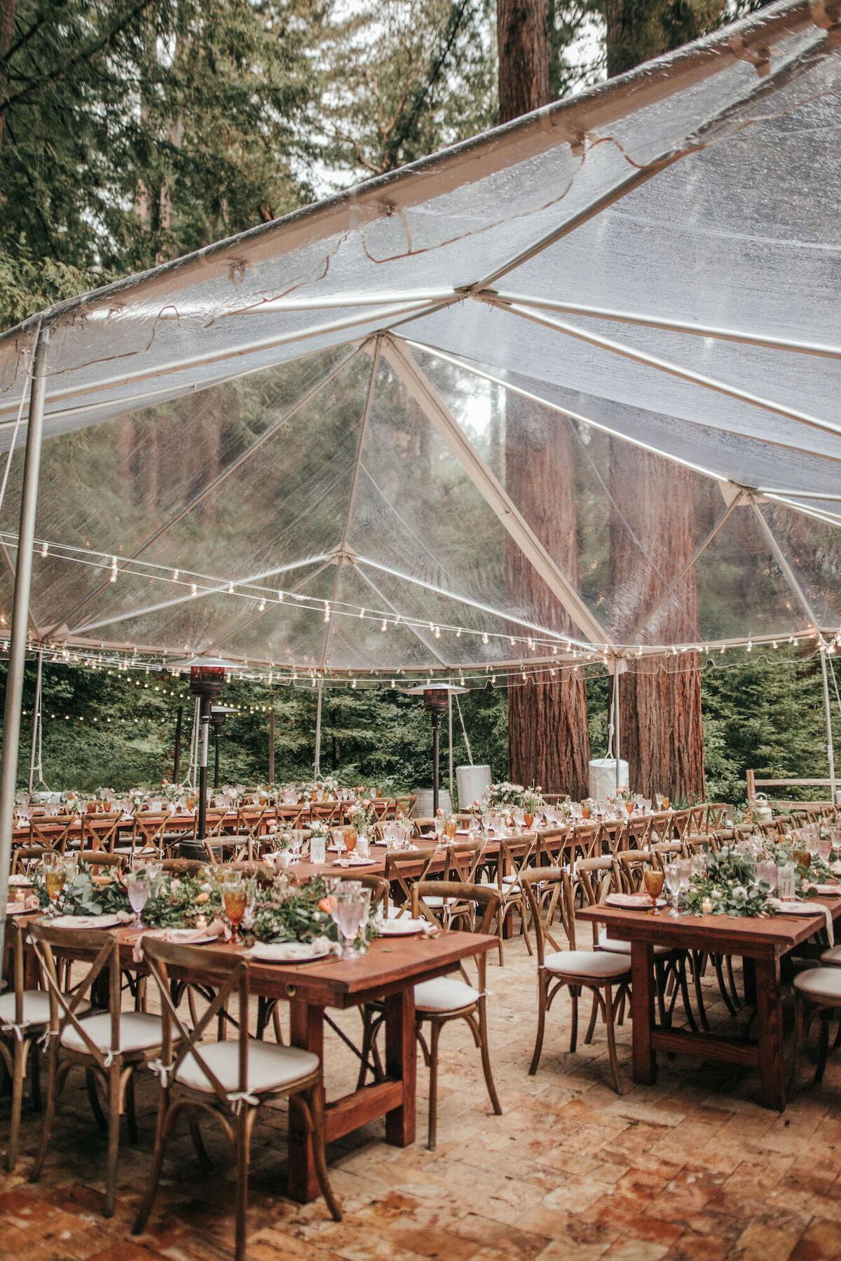 Forested wedding reception under a canopy