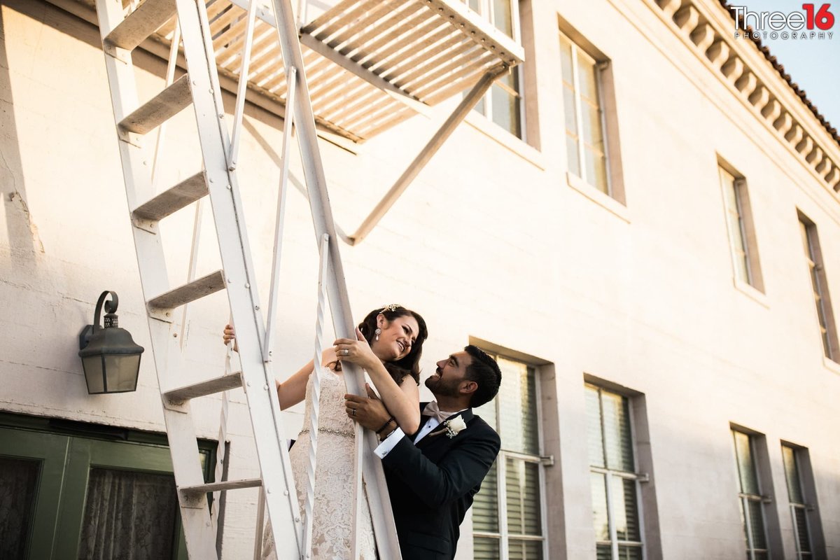 Bride and Groom pose on a stairwell ala "Pretty Woman"