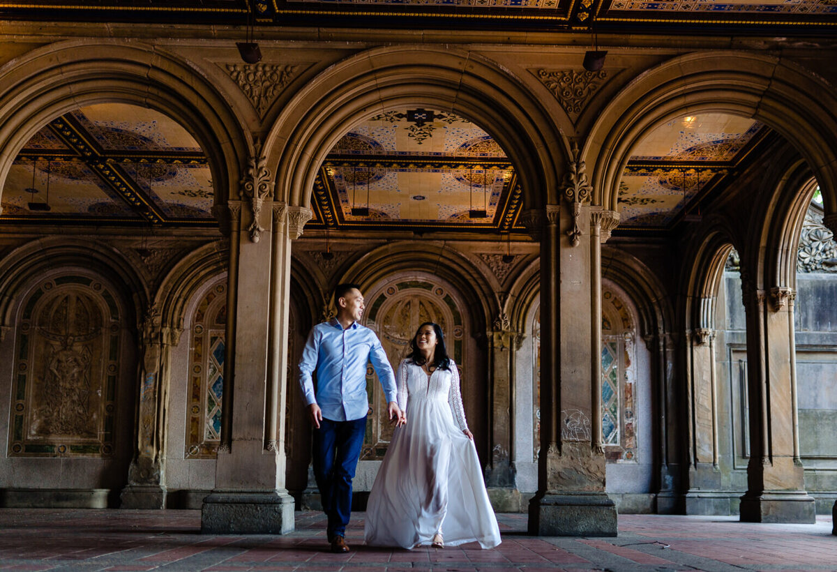 couple-walks-holding-hands-beneath-bethesda-terrace-austin-wedding-photographer-john-winters-photography-1536x1049