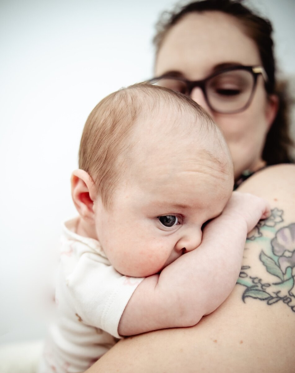A new mama kisses her 2 day old baby