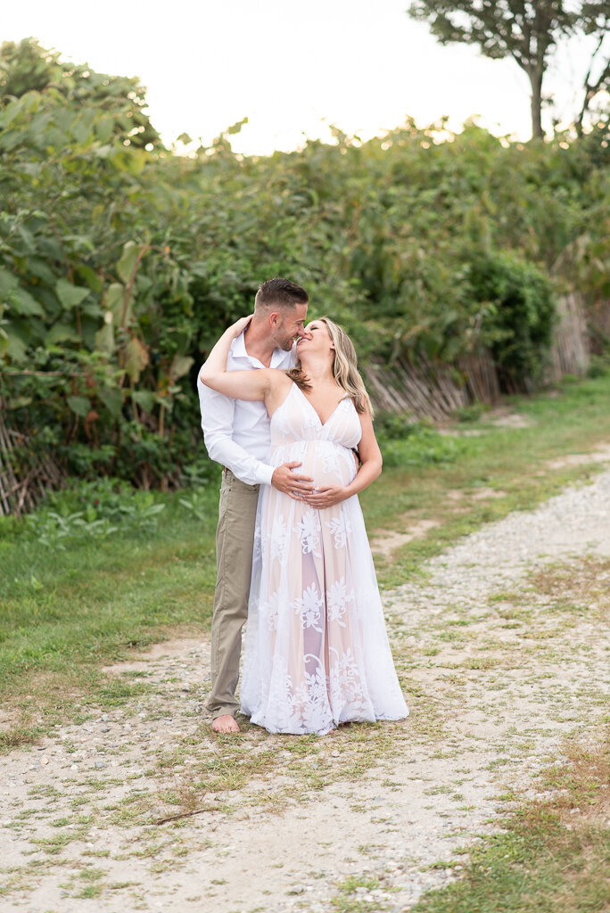 Expecting couple kissing on the beach at sunset pregnancy session |Sharon Leger Photography || Canton, CT || Family & Newborn Photographer