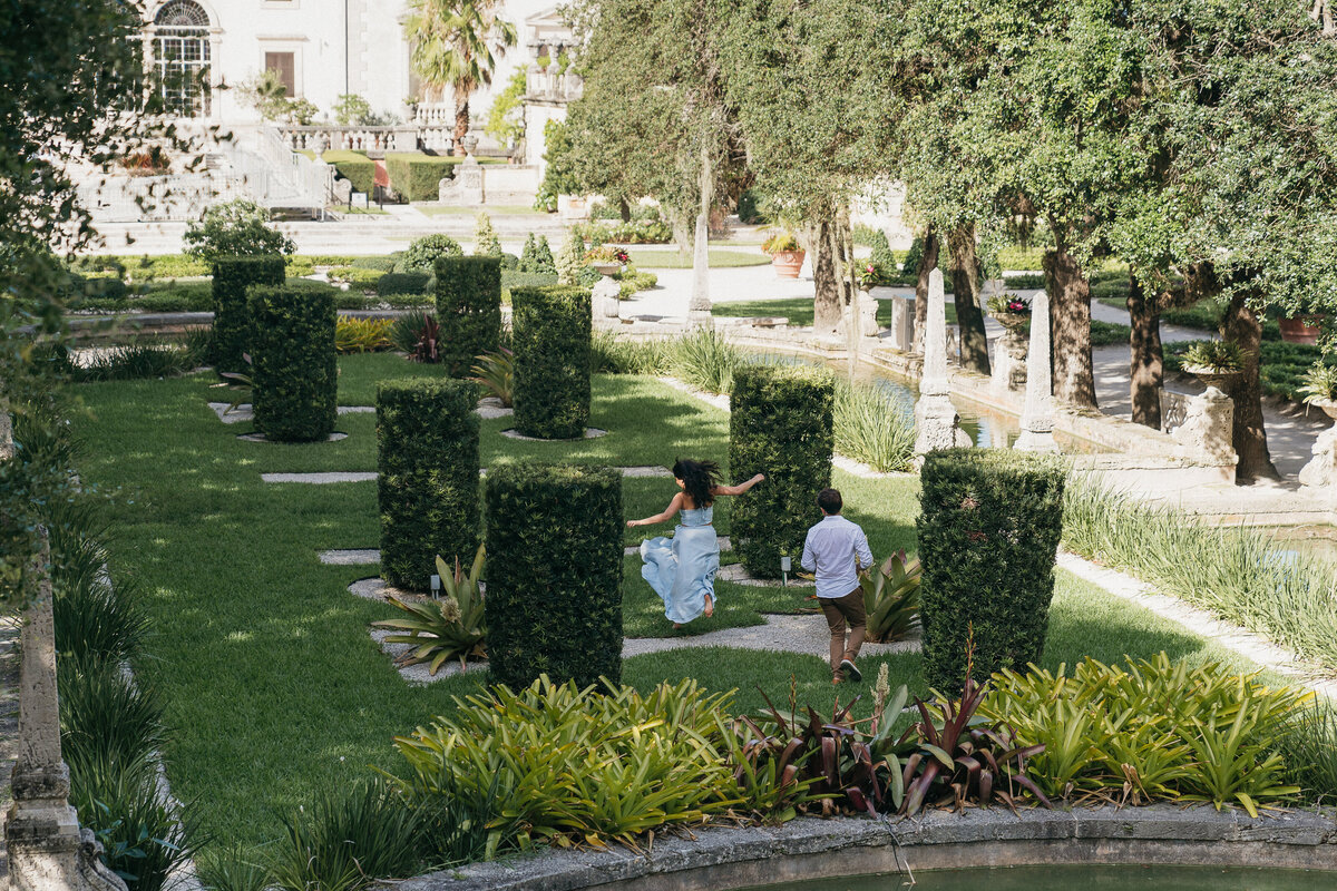couple running through vizcaya garden by east coast photographer Shelby Ann Photos