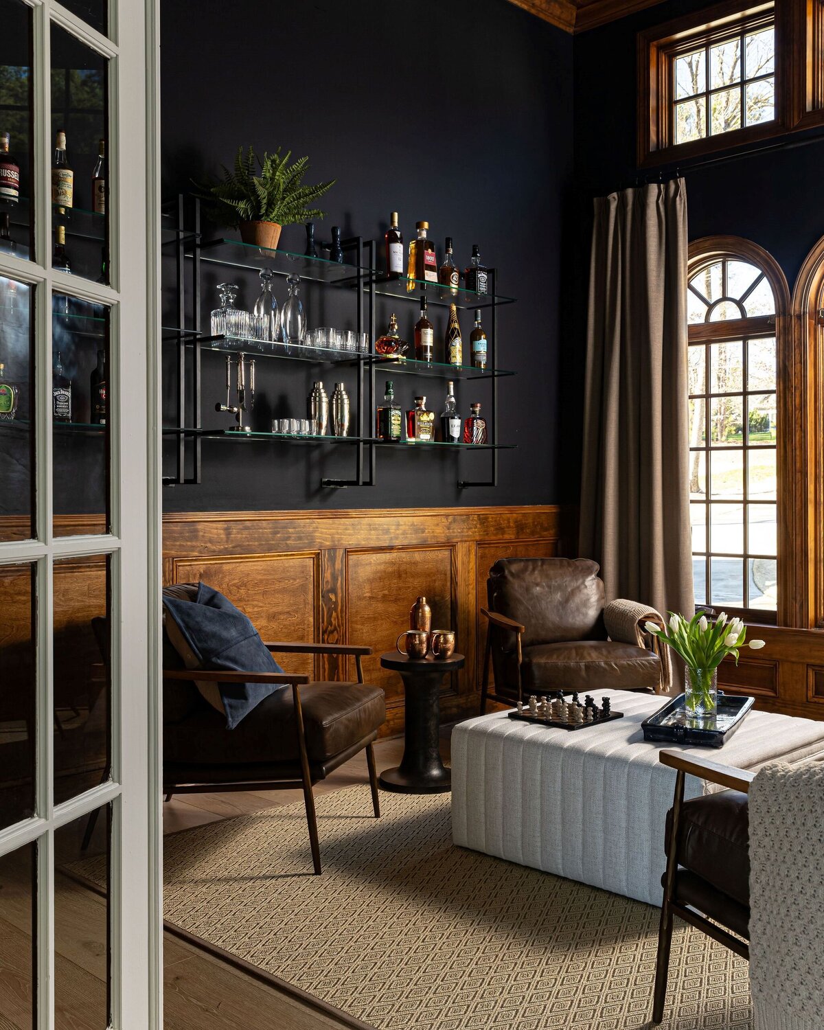 lounge with glass shelves, dark walls, and moody vibe