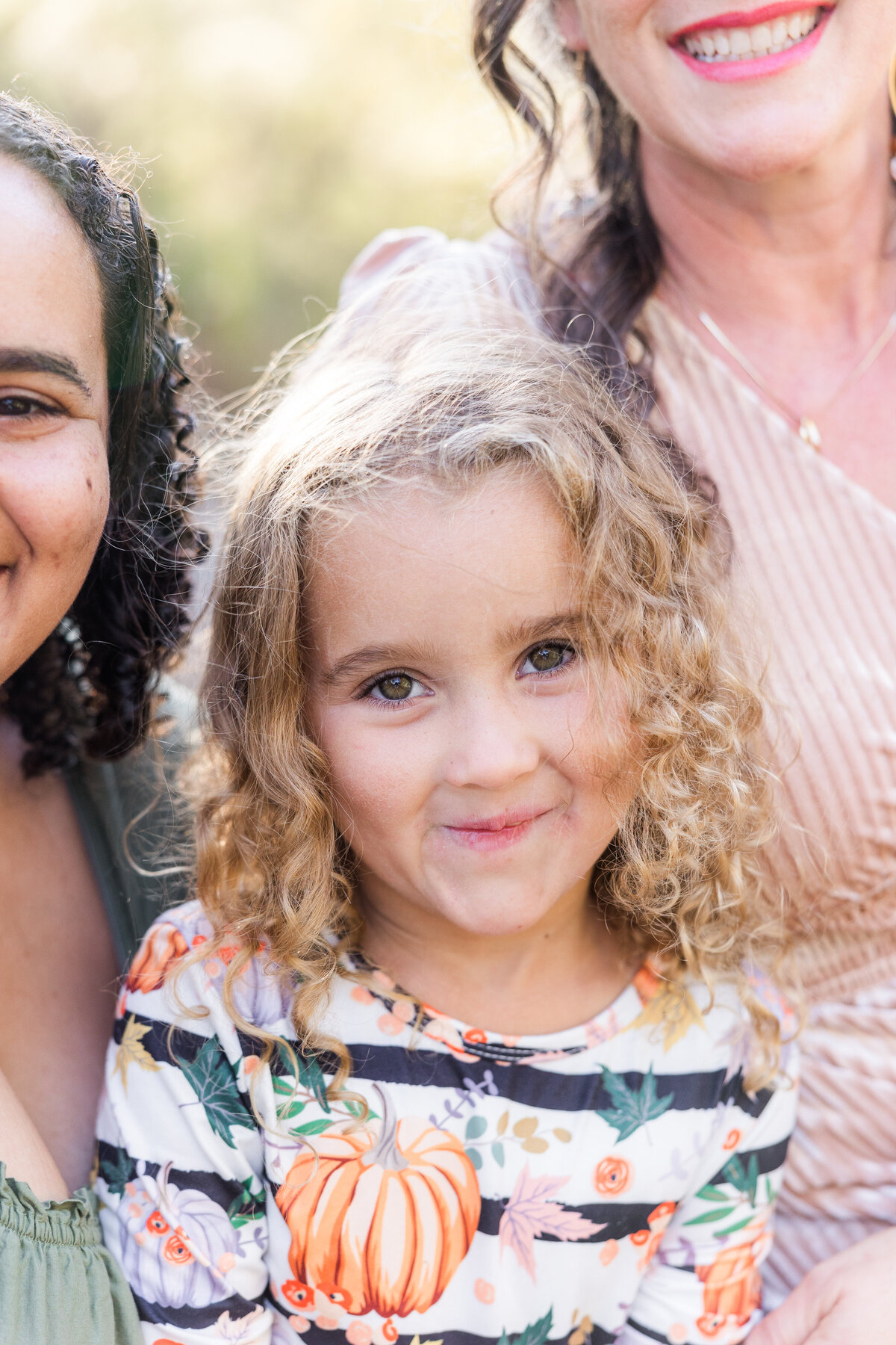 young girl sitting between mother and grandmother