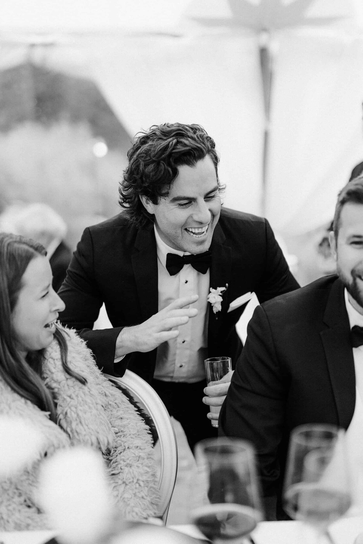 Laughing groomsman at a wedding reception