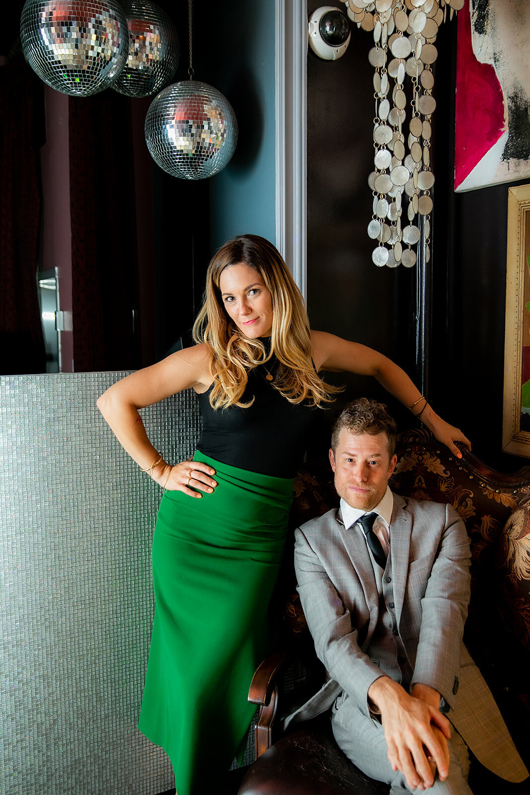 Event Experts pose in a stylish lounge with disco balls and eclectic decor