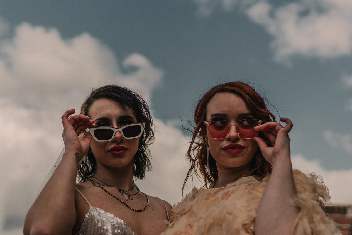 Cool wedding photography of two brides in sunglasses