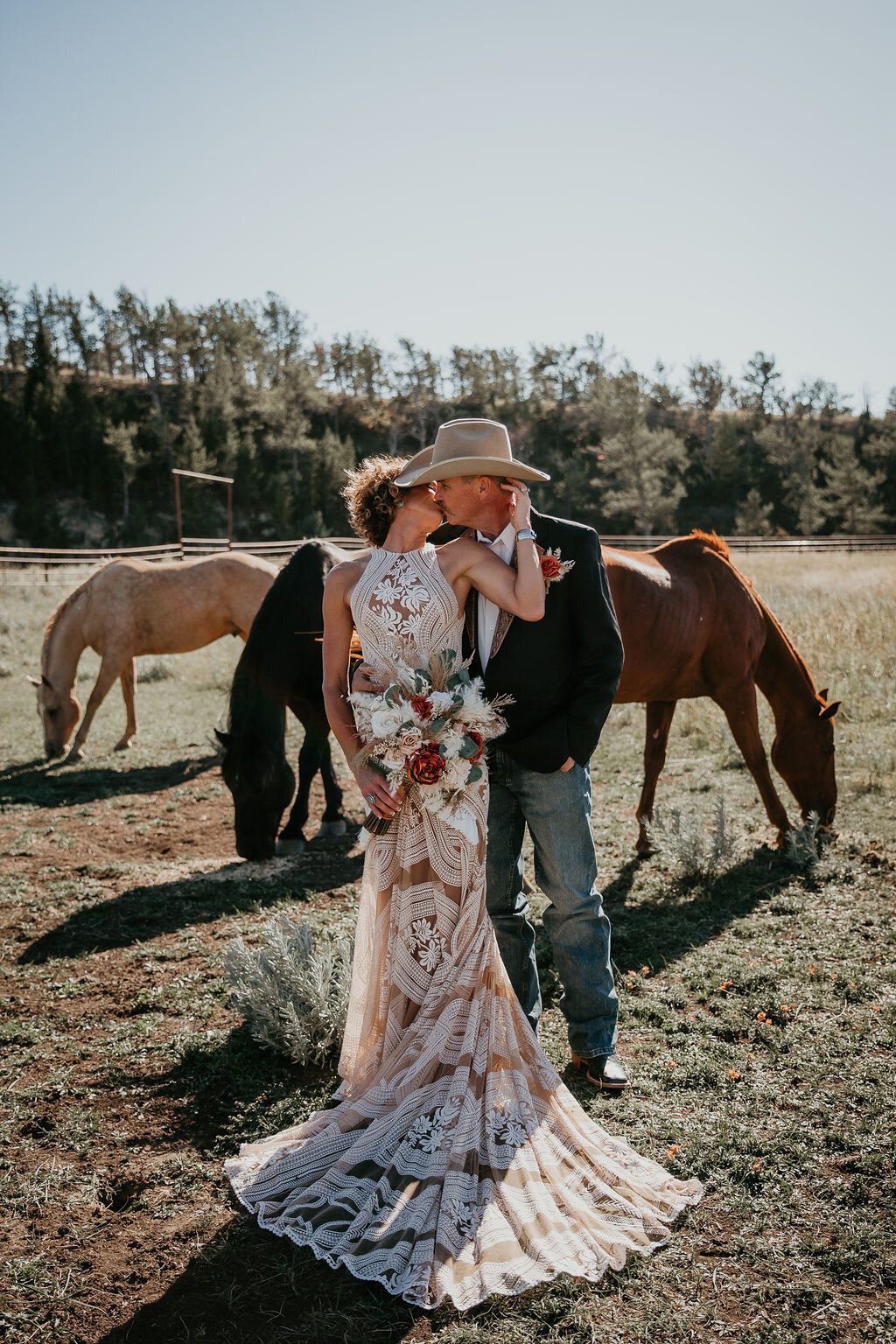 Bride and groom with horses in Montana