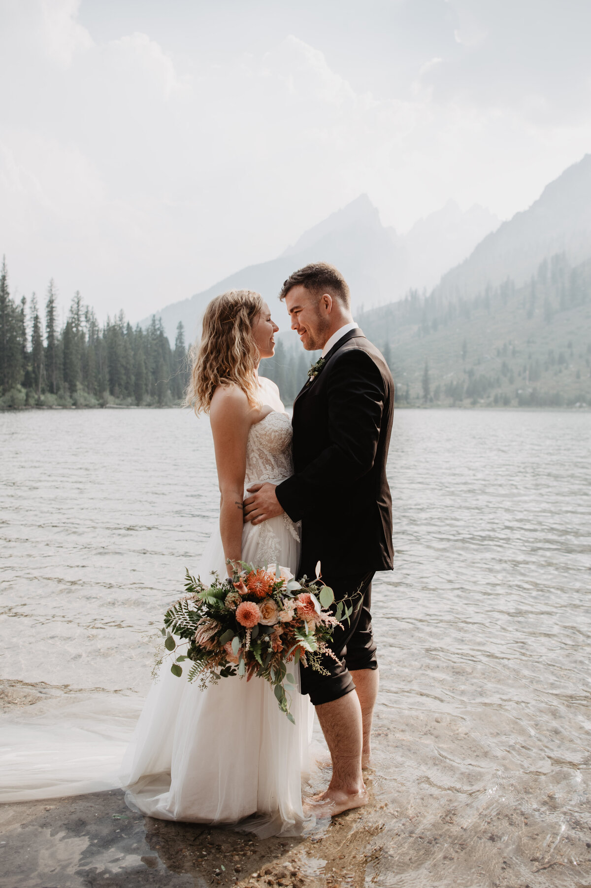 Jackson Hole Photographers capture couple looking at one another during adventure elopement portraits