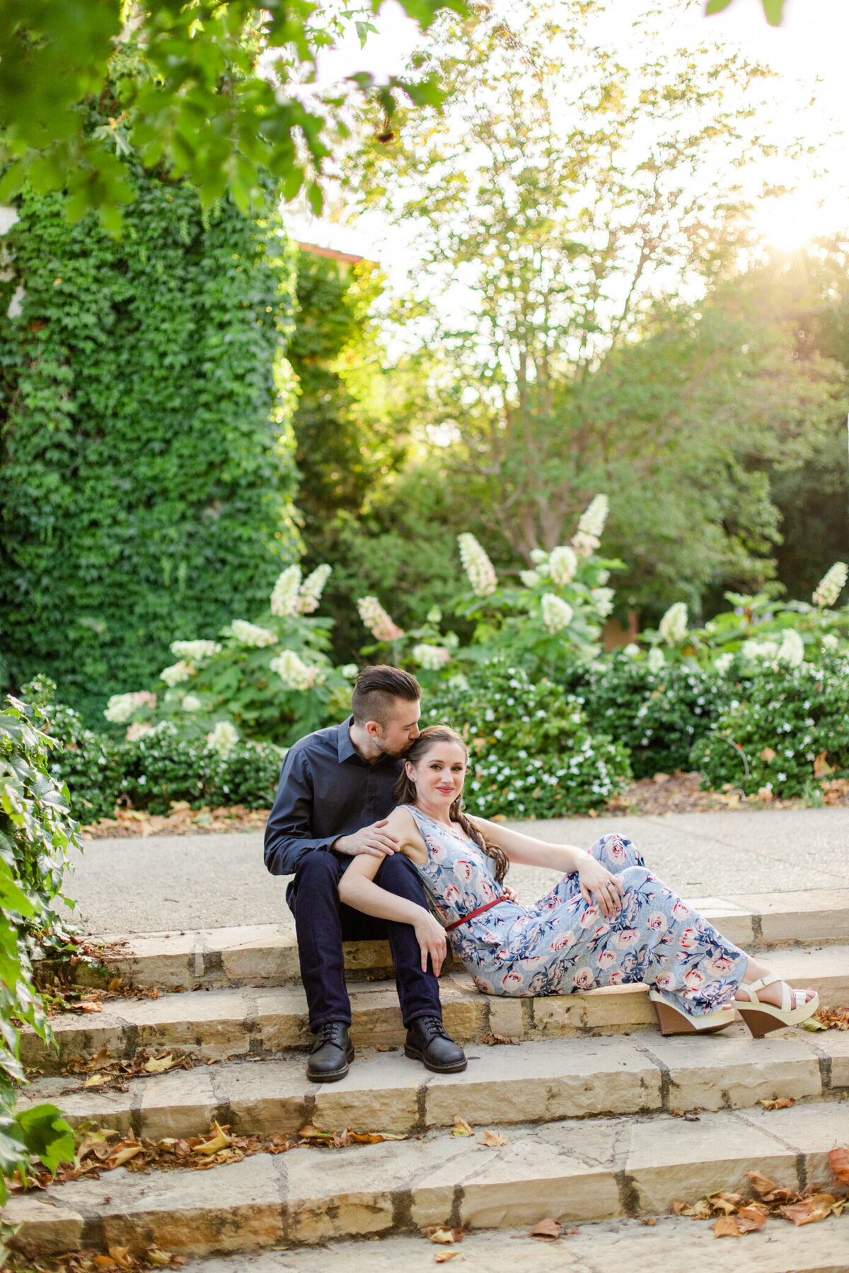bride and groom-to-be hug on a stair case