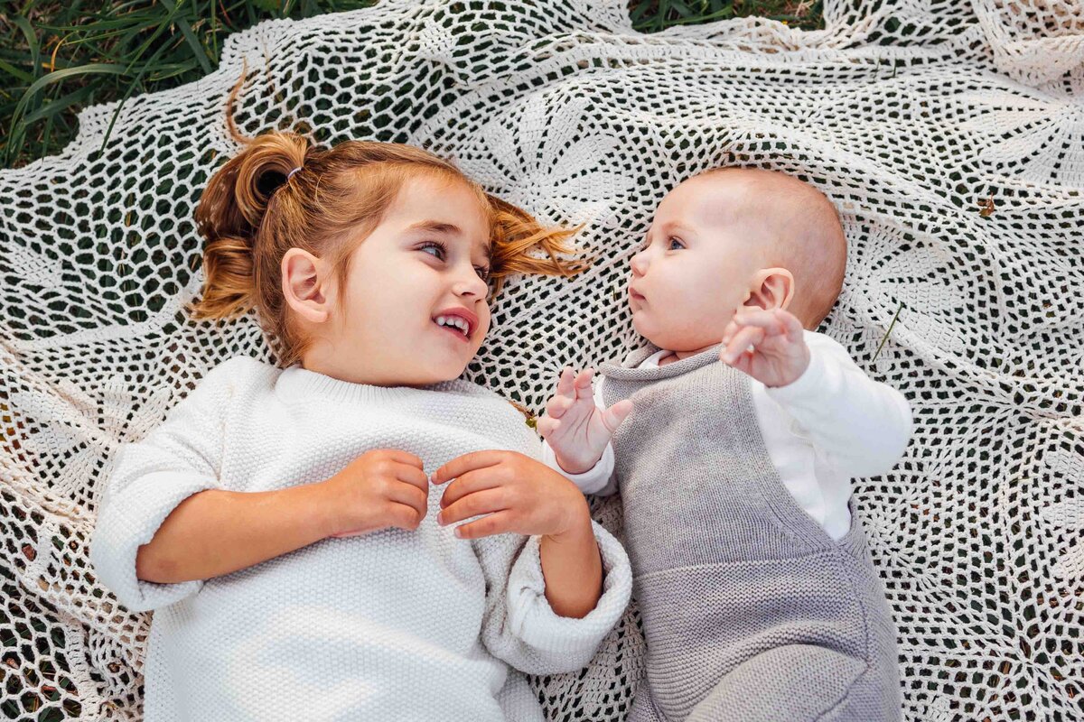 siblings laying on blanket long island family photo shoot