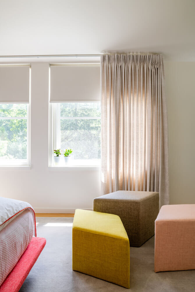 Top designer in Boston creates a modern kids' bedroom in a Hingham new build home with geometric ottomans and custom Walter G textile drapery panels.