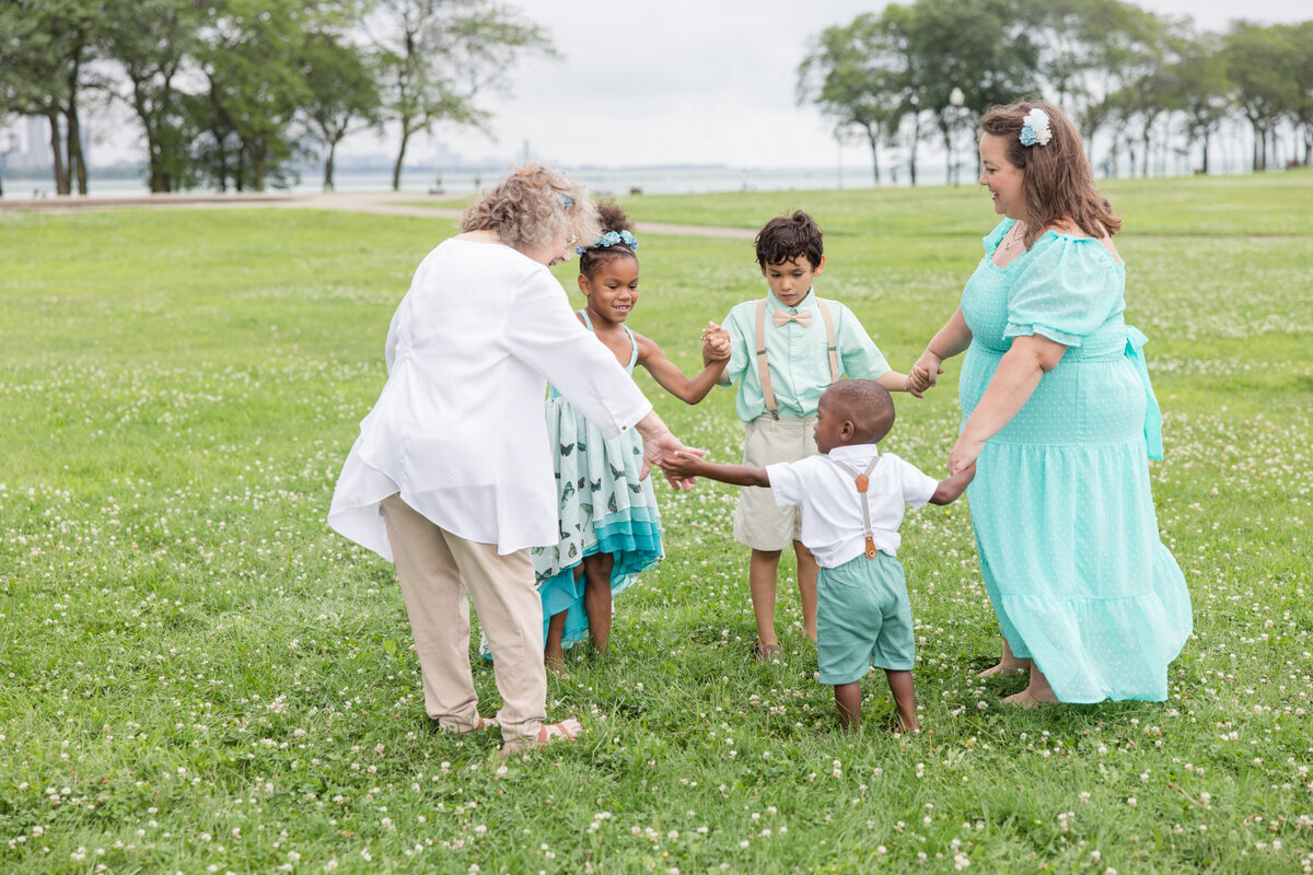 mom and kids playing family photos michigan grass