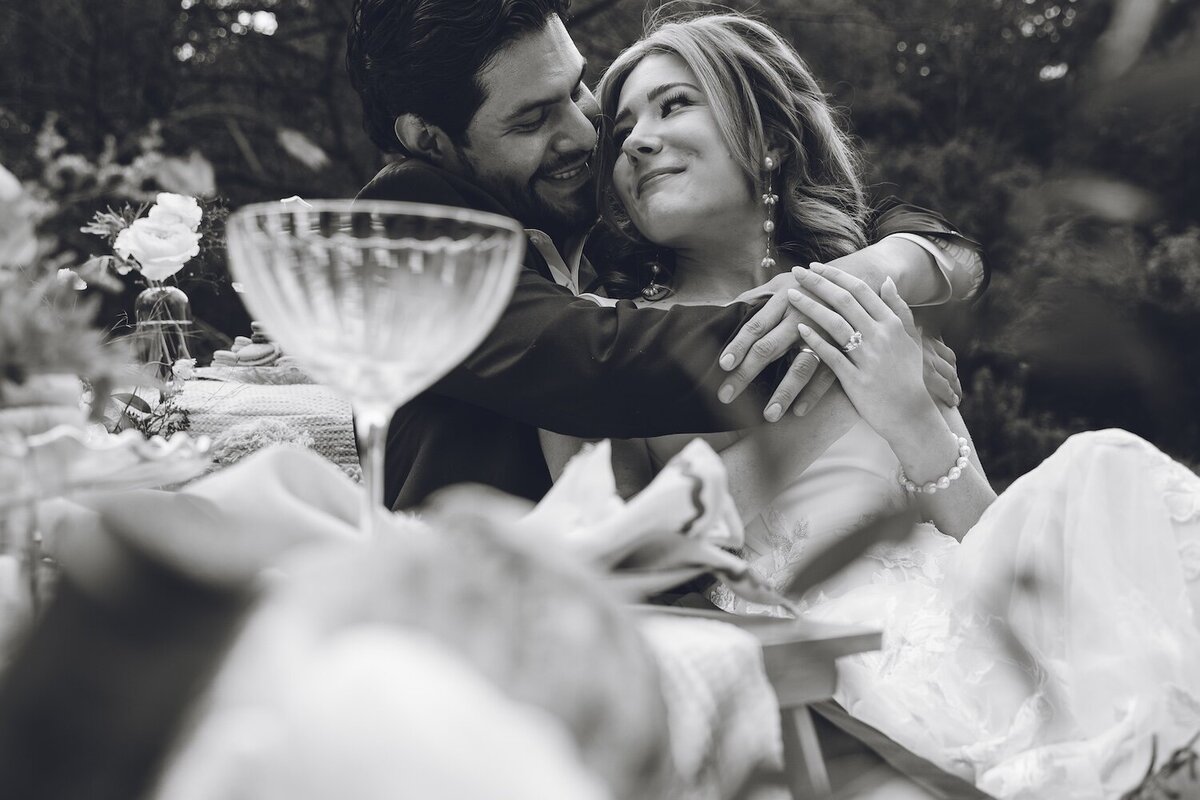Groom and bride smiling with champagne and vintage glasses