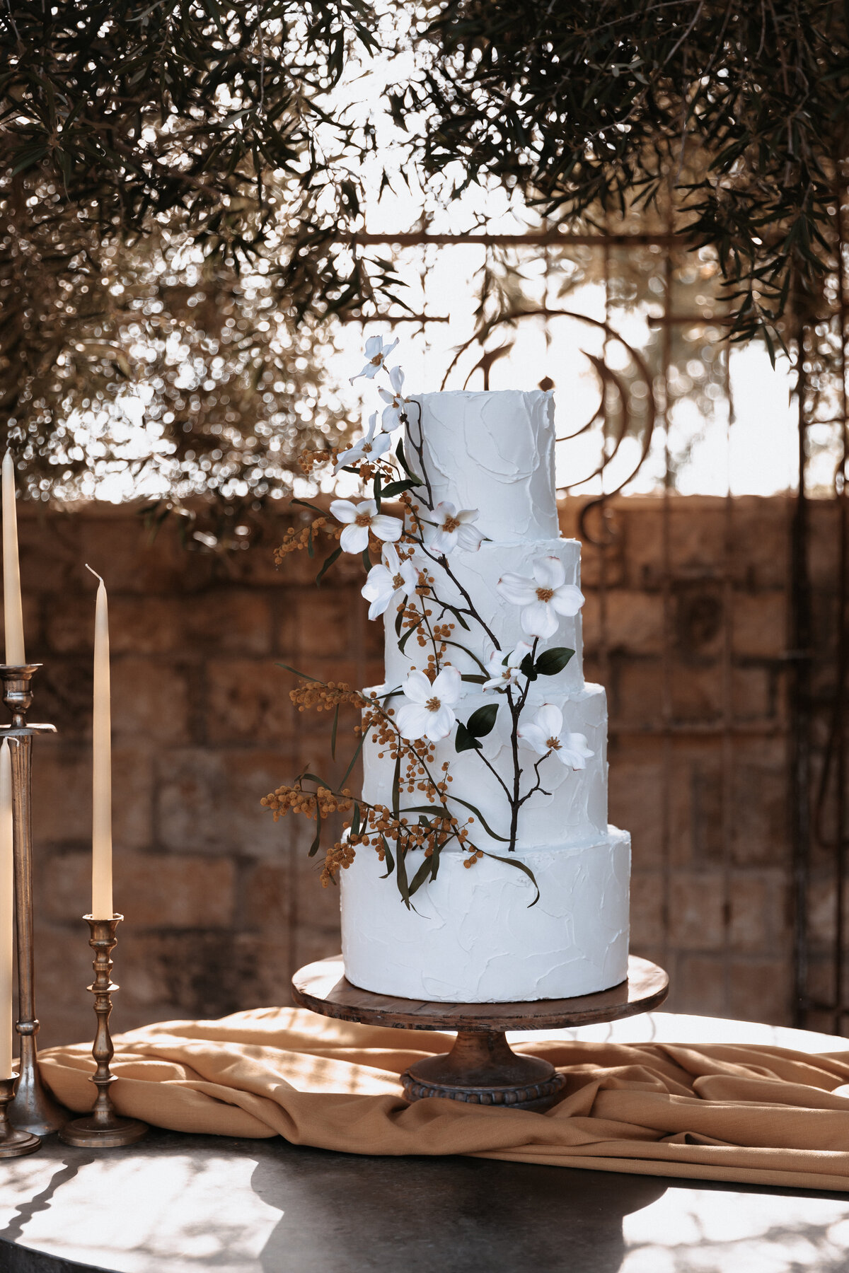 Elopement Photography, white wedding cake with brown tones on a table with fabric