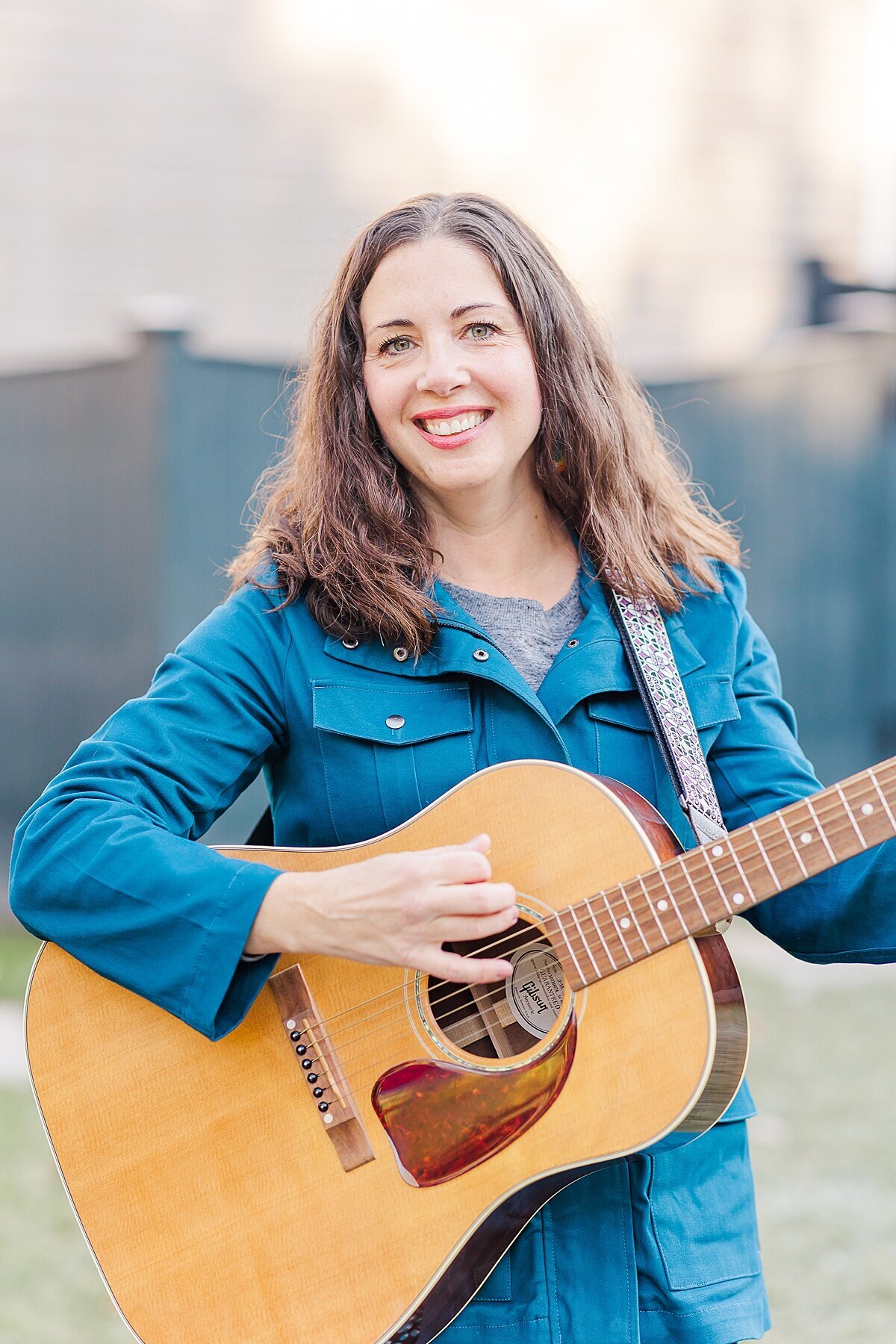 Stacey Peasley plays guitar during Stacey Peasley Band Branding photo session with Sara Sniderman Photography in Natick Massachusetts