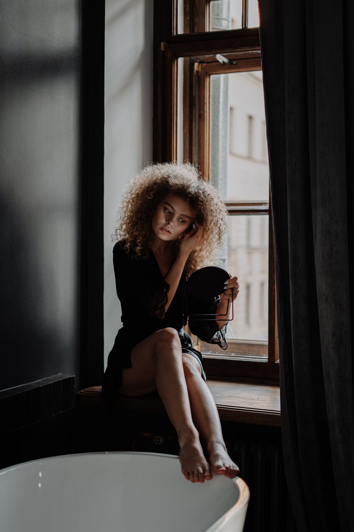 woman-in-black-dress-sitting-on-window-4154989