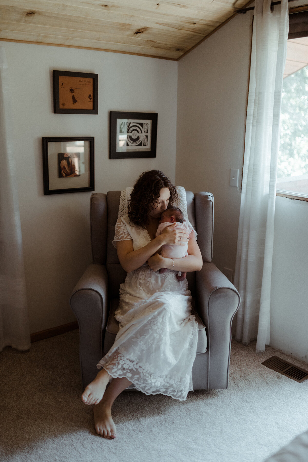 Mom holding baby in nursery