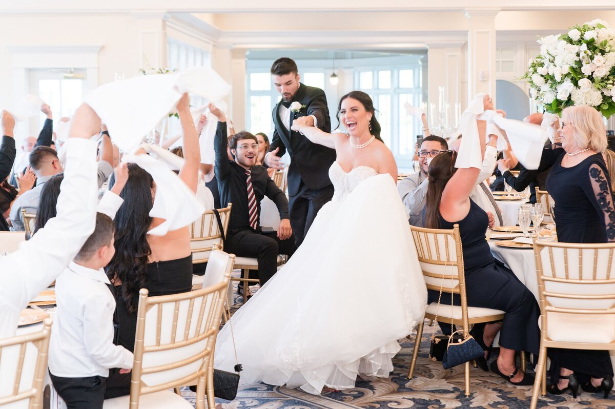 couple entering wedding reception